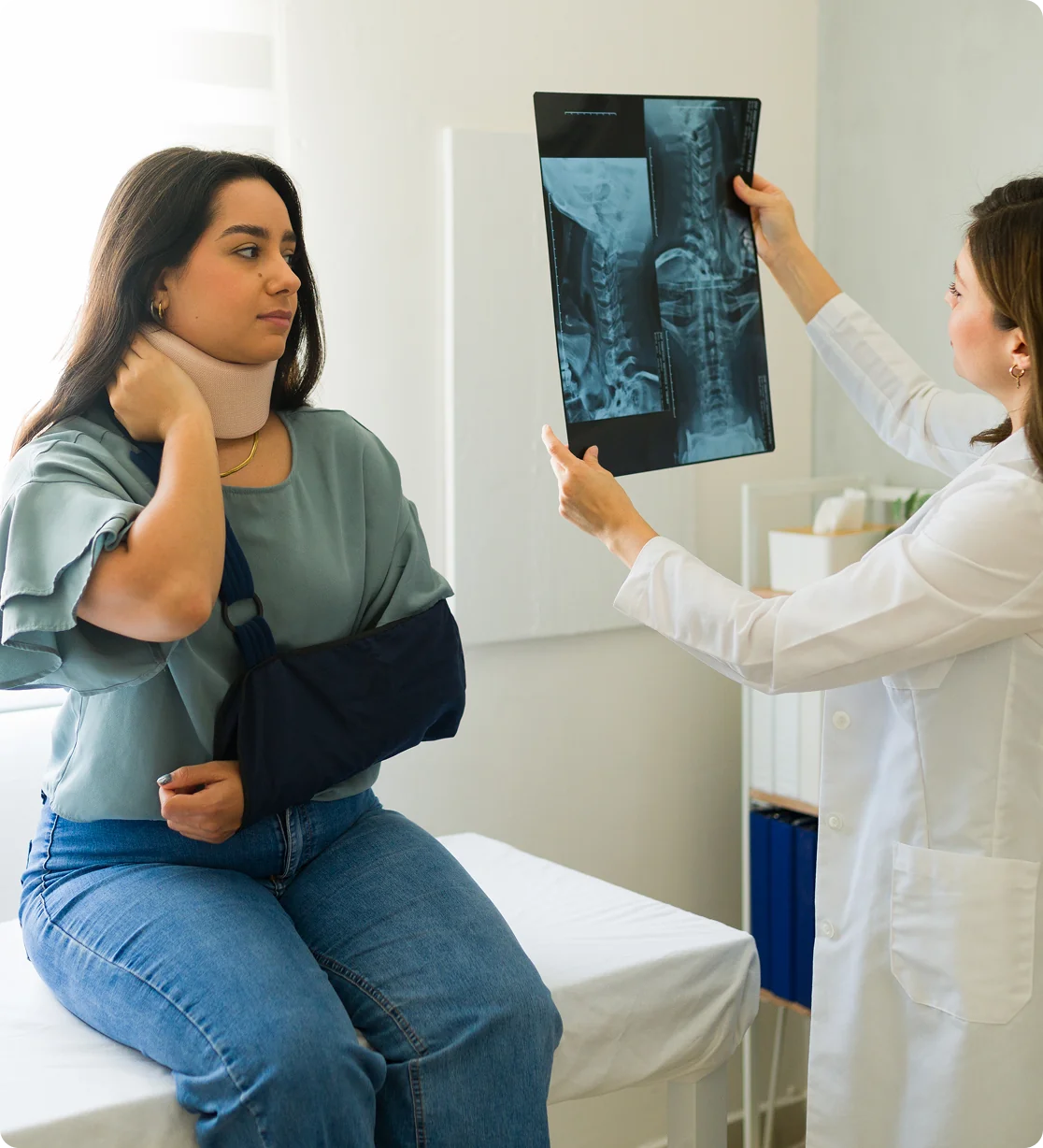 Doctor examines patient's neck X-ray.